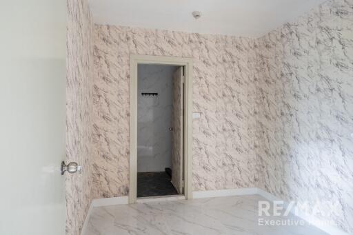 Bedroom with marble-patterned walls and floor