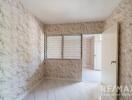 Empty bedroom with marble-patterned wallpaper