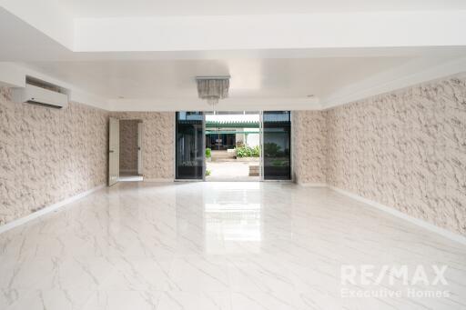 Spacious living room with marble flooring and modern chandelier