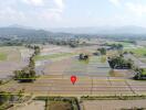 Aerial view of farmland with surrounding hills, marked with a property boundary.