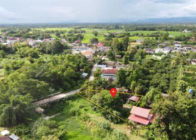 Aerial view of a property with surrounding greenery