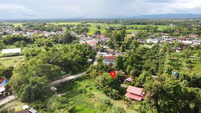 Aerial view of a property with surrounding greenery