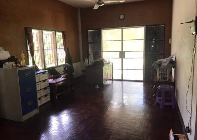 Spacious living room with parquet flooring and large windows