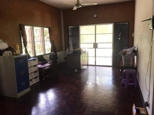 Spacious living room with parquet flooring and large windows