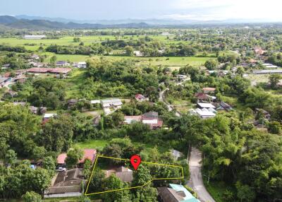 Aerial view of a property and surrounding neighborhood with a highlighted plot