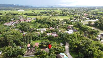 Aerial view of a property and surrounding neighborhood with a highlighted plot