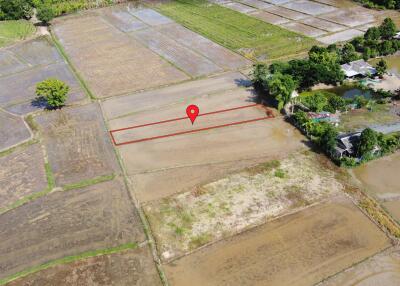 Aerial view of a plot of land with a pin marker