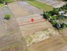 Aerial view of a plot of land with a pin marker