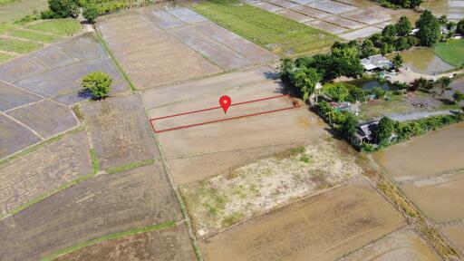 Aerial view of a plot of land with a pin marker