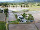 Aerial view of rural property with rice fields