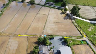 Aerial view of agricultural plots and adjacent houses