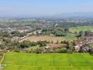 Aerial view of green fields and surrounding area