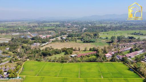 Aerial view of green fields and surrounding area