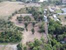 Aerial view of a plot of land surrounded by vegetation