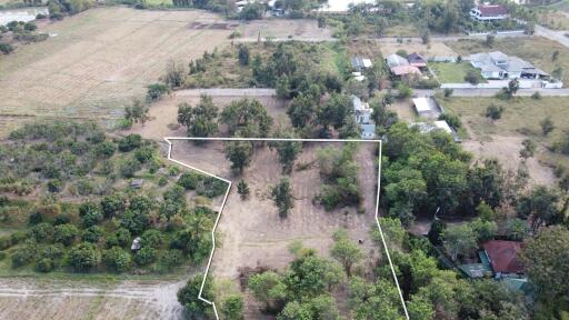 Aerial view of a plot of land surrounded by vegetation