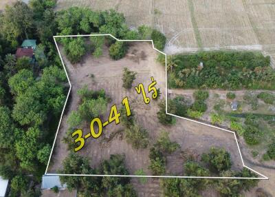 Aerial view of a plot of land bounded by white lines with area designation in yellow numbers