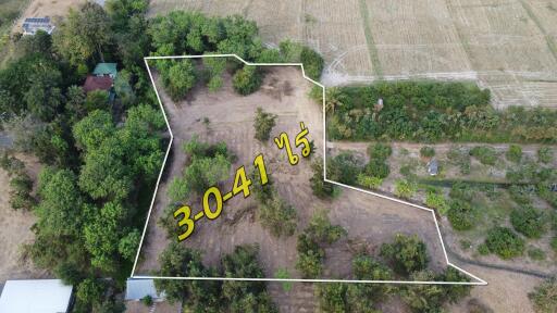 Aerial view of a plot of land bounded by white lines with area designation in yellow numbers