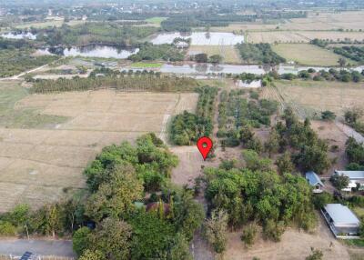 Aerial view of rural property with a red pin marking a specific location