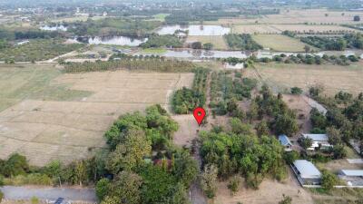 Aerial view of rural property with a red pin marking a specific location