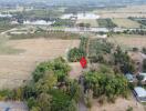 Aerial view of rural property with a red pin marking a specific location