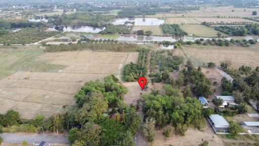 Aerial view of rural property with a red pin marking a specific location