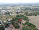 Aerial view of a rural landscape with roads, buildings, and greenery.