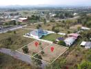 Aerial view of a neighborhood with plots of land marked