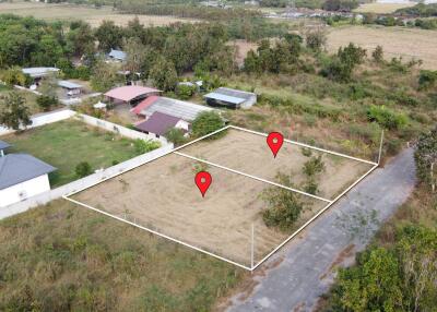 Aerial view of two adjacent land plots marked for sale