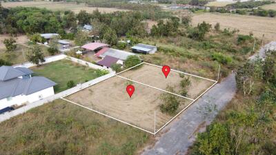 Aerial view of two adjacent land plots marked for sale