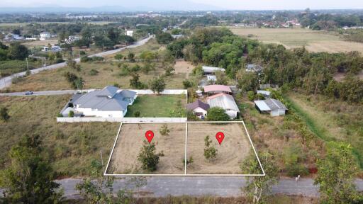 Aerial view of land and surrounding properties