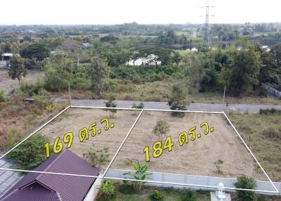 Two adjacent plots of land labeled with dimensions available for sale in a residential area