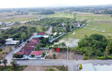 Aerial view of a residential neighborhood with a highlighted land plot