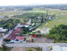 Aerial view of a residential neighborhood with a highlighted land plot