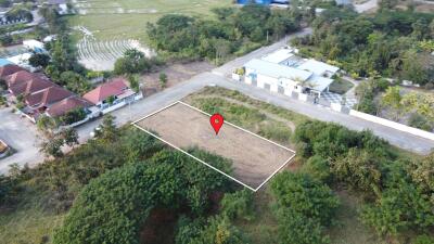 Aerial view of a plotted land area with surrounding greenery