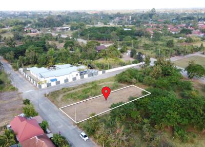 Aerial view of an available building plot marked with a red pin