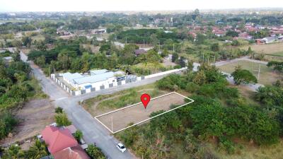 Aerial view of an available building plot marked with a red pin