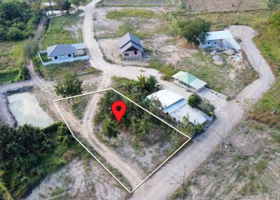 Aerial view of land with a property marker