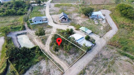 Aerial view of land with a property marker