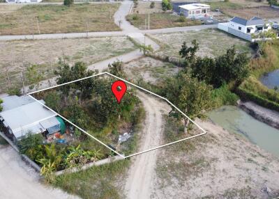 Aerial view of a land plot with surrounding area