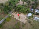 Aerial view of a plot of land marked with a red location pin