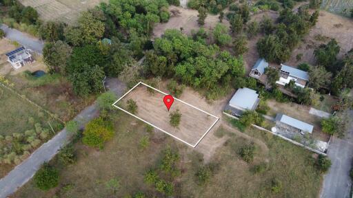 Aerial view of a plot of land marked with a red location pin