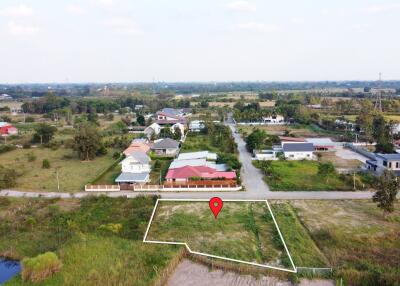 Aerial view of a land plot in a residential neighborhood