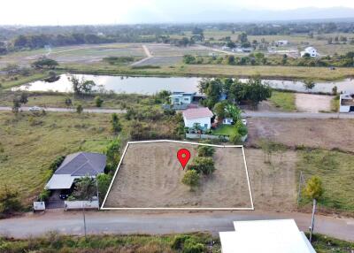 Aerial view of a vacant plot of land marked for sale