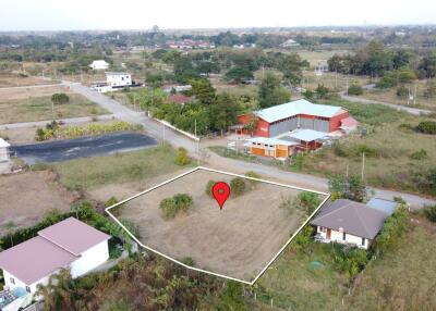 Aerial view of a vacant plot of land with surrounding buildings