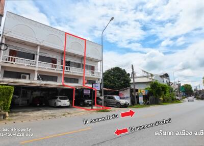 Street view of a building with multiple units and parked cars