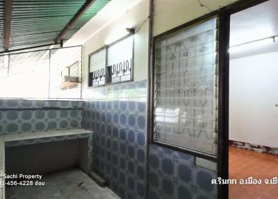 Kitchen area with tiled walls and countertop