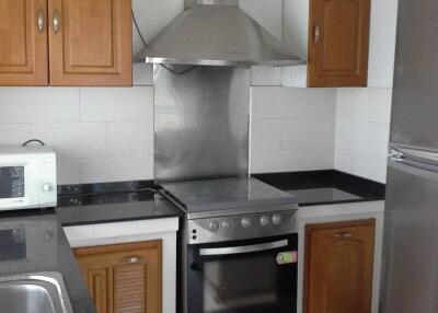 Modern kitchen with wooden cabinets, stainless steel appliances, and a sleek design