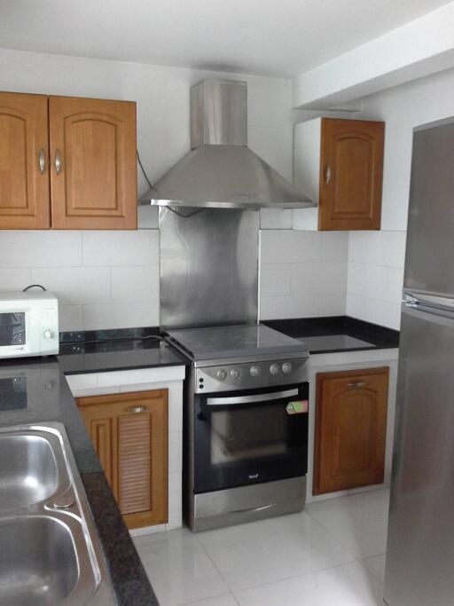 Modern kitchen with wooden cabinets, stainless steel appliances, and a sleek design