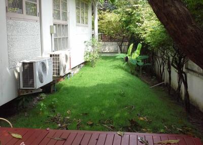 Backyard with green lawn and deck area