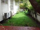 Backyard with green lawn and deck area